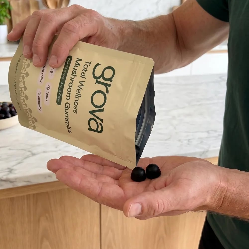 Grova mushroom gummies being poured into a hand